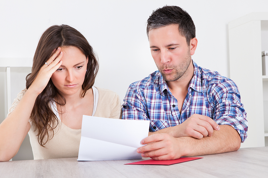 Worried Couple Reading Paper Received an IRS Letter